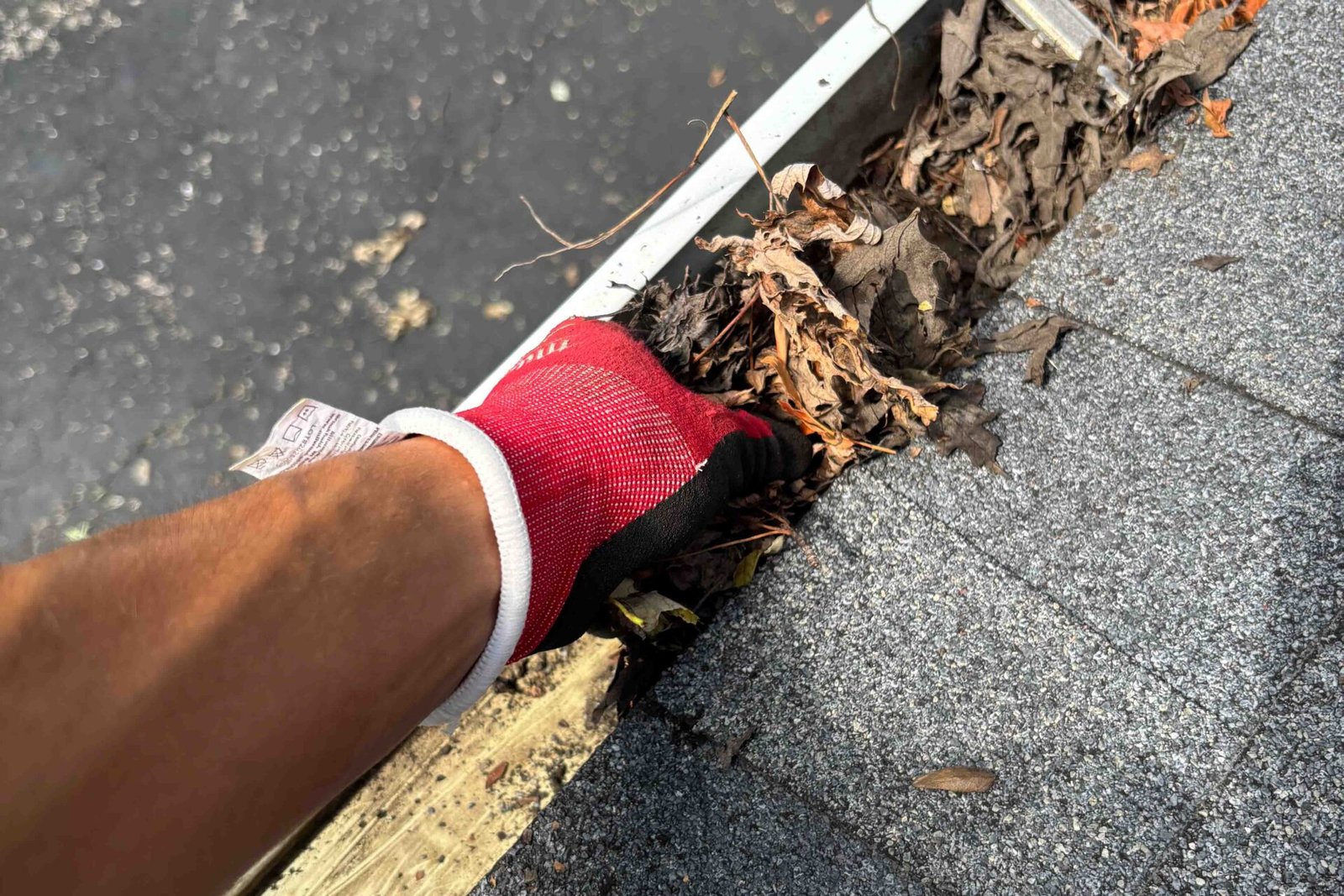Technician performing gutter cleaning on a two-story home in Naperville IL